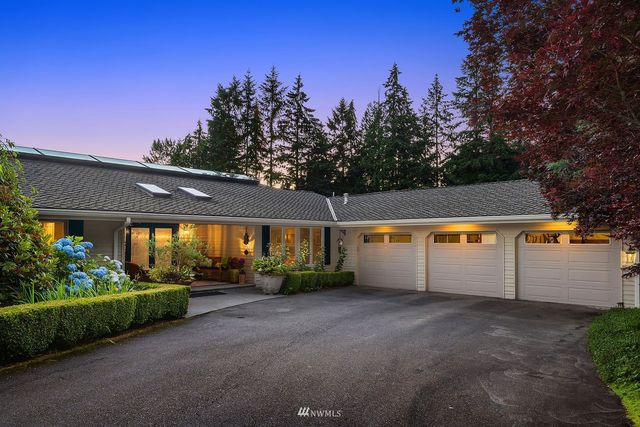 a view of a house with a yard and tree s