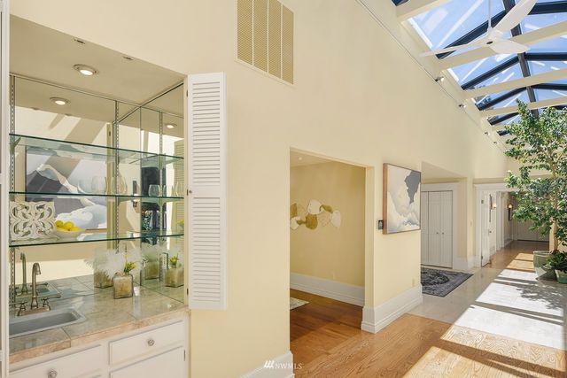 a view of a hallway and a dining room view of wooden floor