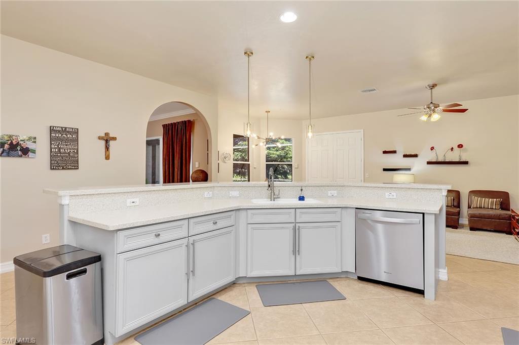 14611 Indigo Lakes Circle Naples, FL 34119 - Photo 13 of 31 a kitchen with white cabinets and sink