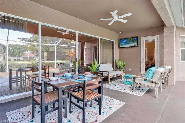 a dining room with furniture a chandelier and wooden floor