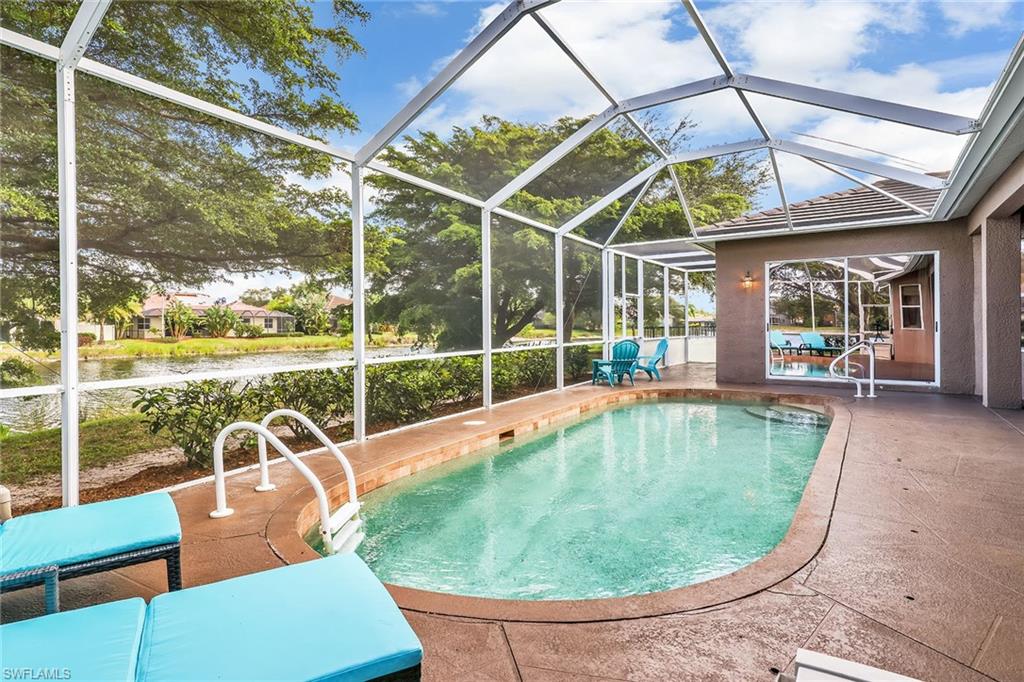 14611 Indigo Lakes Circle Naples, FL 34119 - Photo 17 of 31 a view of a swimming pool with a patio