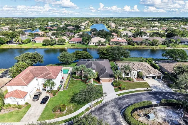 an aerial view of a house with a garden and lake view