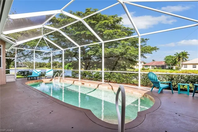 a view of a backyard with swimming pool