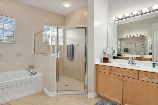 a bathroom with a tub sink and mirror