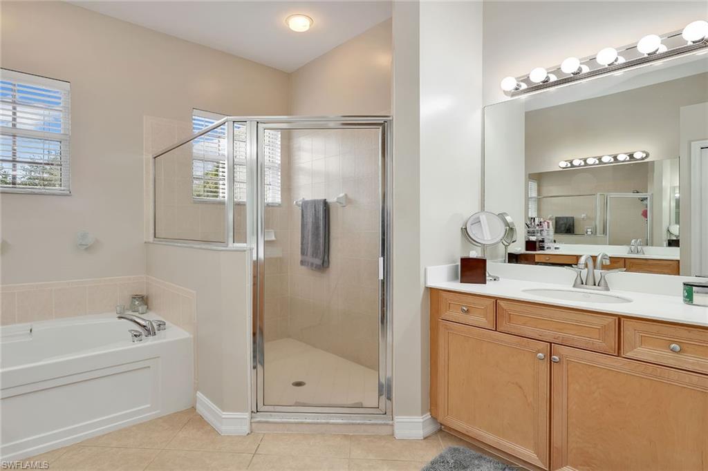 14611 Indigo Lakes Circle Naples, FL 34119 - Photo 23 of 31 a bathroom with a tub sink and mirror