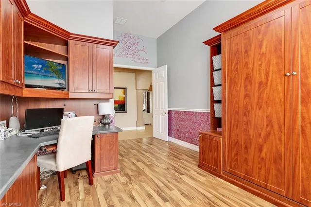 a view of a kitchen with a table and chairs in it