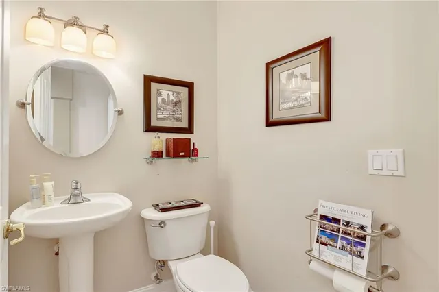 a bathroom with a toilet a sink and a mirror