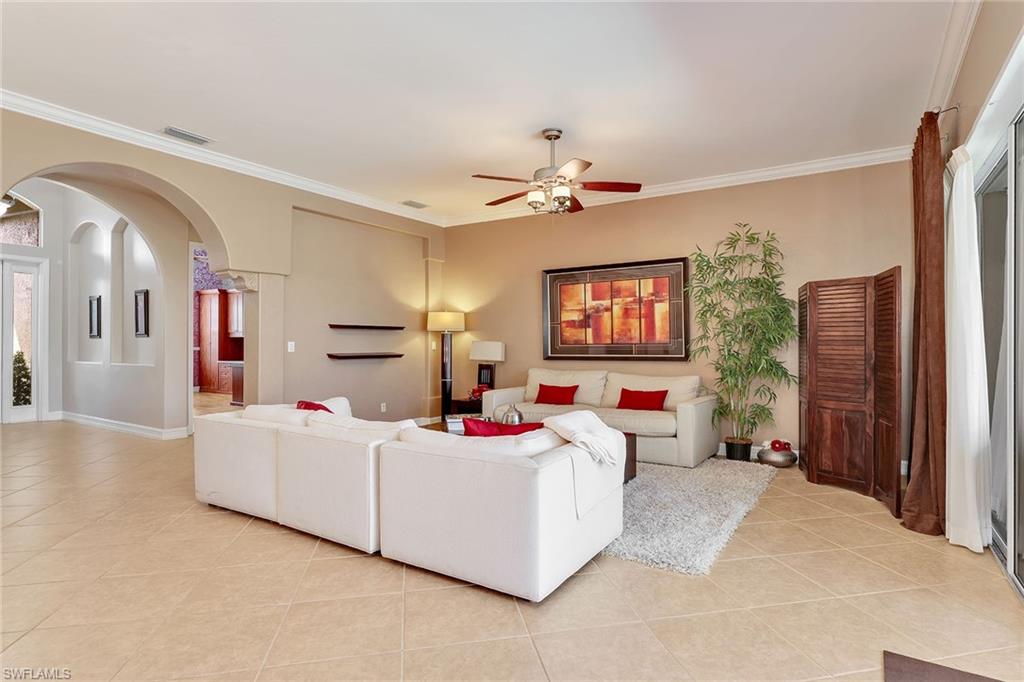 14611 Indigo Lakes Circle Naples, FL 34119 - Photo 8 of 31 a bedroom with furniture and a flat screen tv