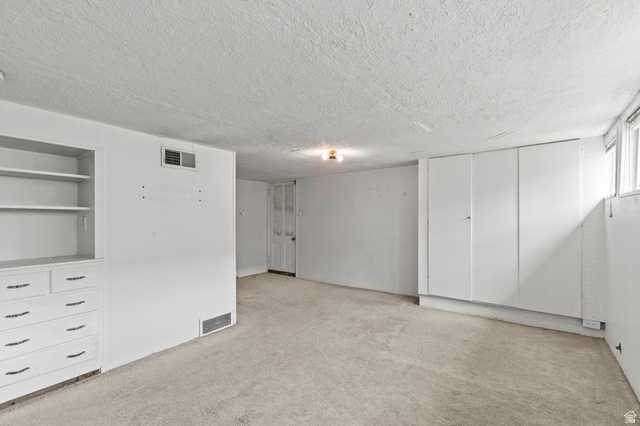 180 South 300 East Logan, UT 84321 - Photo 25 of 35 Unfurnished bedroom with light carpet and a textured ceiling