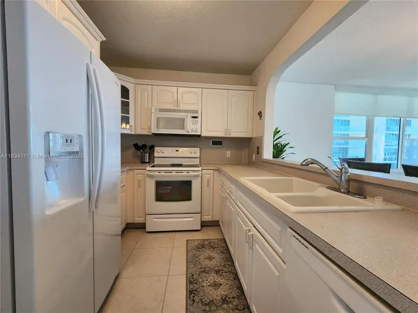 a kitchen with a sink cabinets and stainless steel appliances