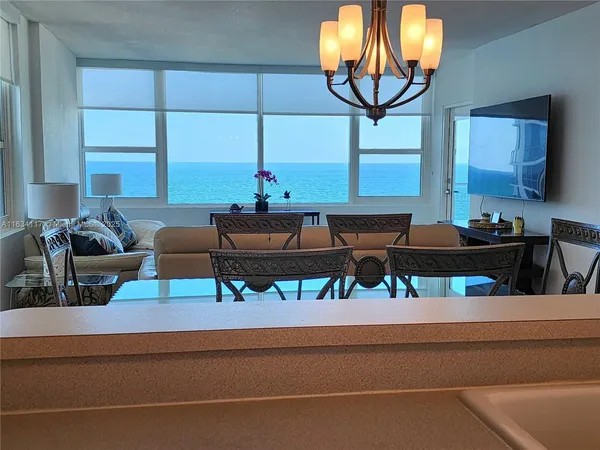 a living room with a couch and a chandelier