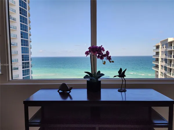 a view of a vase of flowers sitting on a dining table