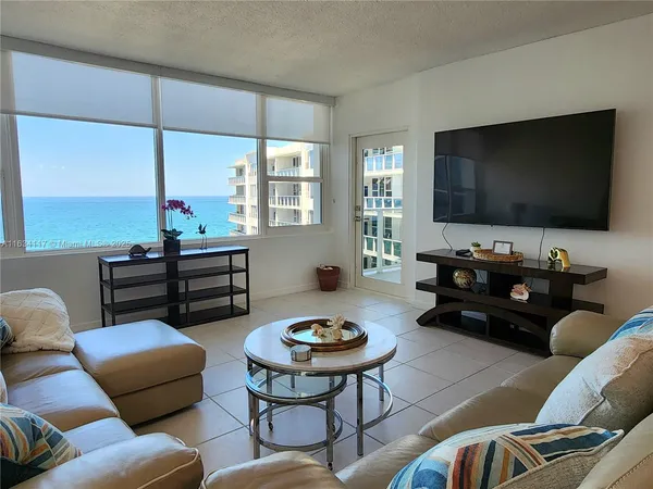 a living room with furniture a rug and a flat screen tv