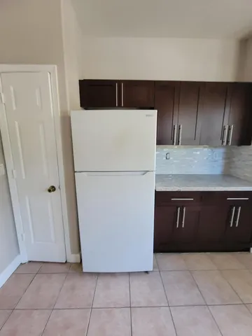 a refrigerator freezer sitting in a kitchen