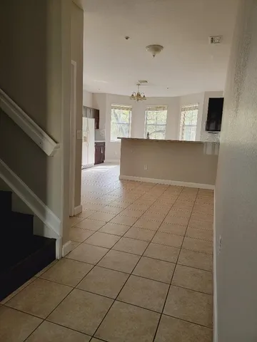 a view of a livingroom with an empty space and a fireplace