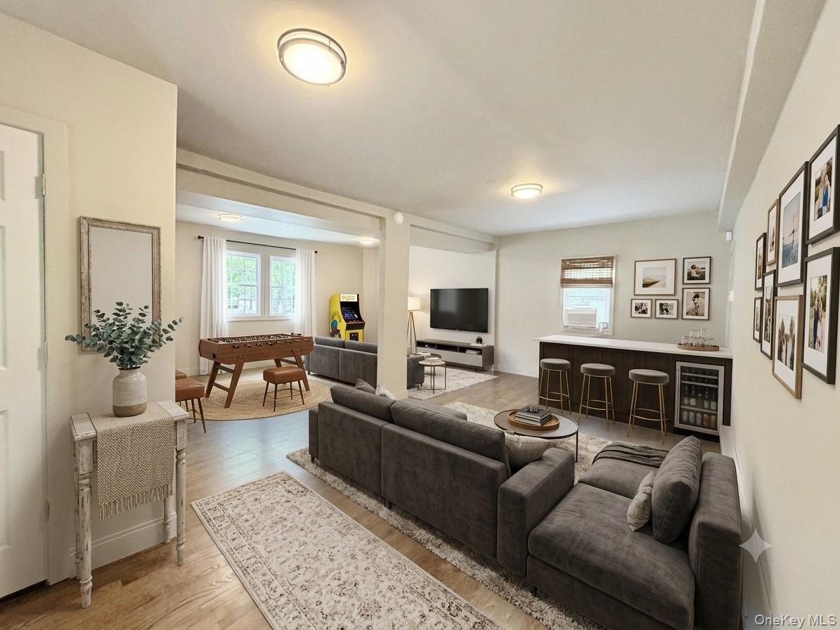 4 Lower Trinity Pass Road Pound Ridge, NY 10576 - Photo 8 of 29 a living room with furniture a flat screen tv and a fireplace