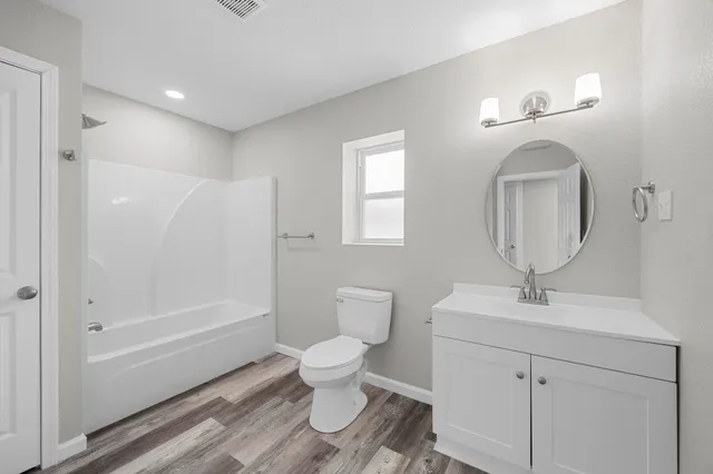 a bathroom with a tub and shower