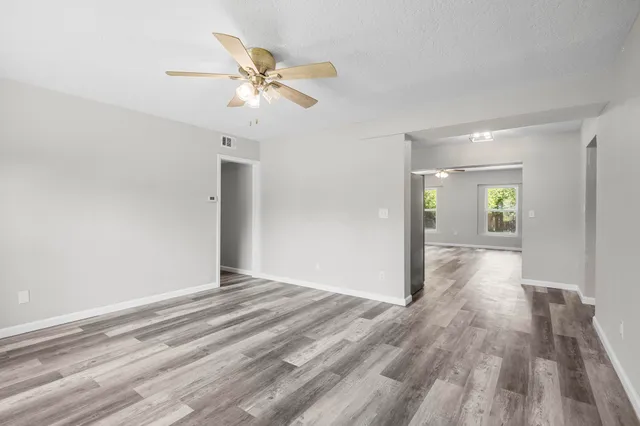 a view of an empty room and wooden floor
