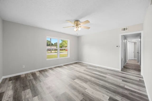 wooden floor in an empty room with a window