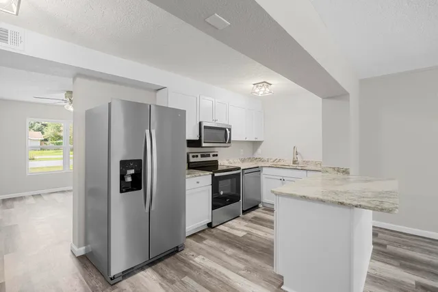 a kitchen with a refrigerator stove and sink