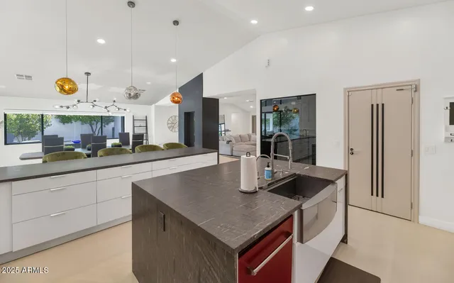 a kitchen with stainless steel appliances granite countertop a sink and a refrigerator
