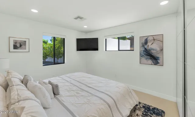 a bedroom with a bed and a window