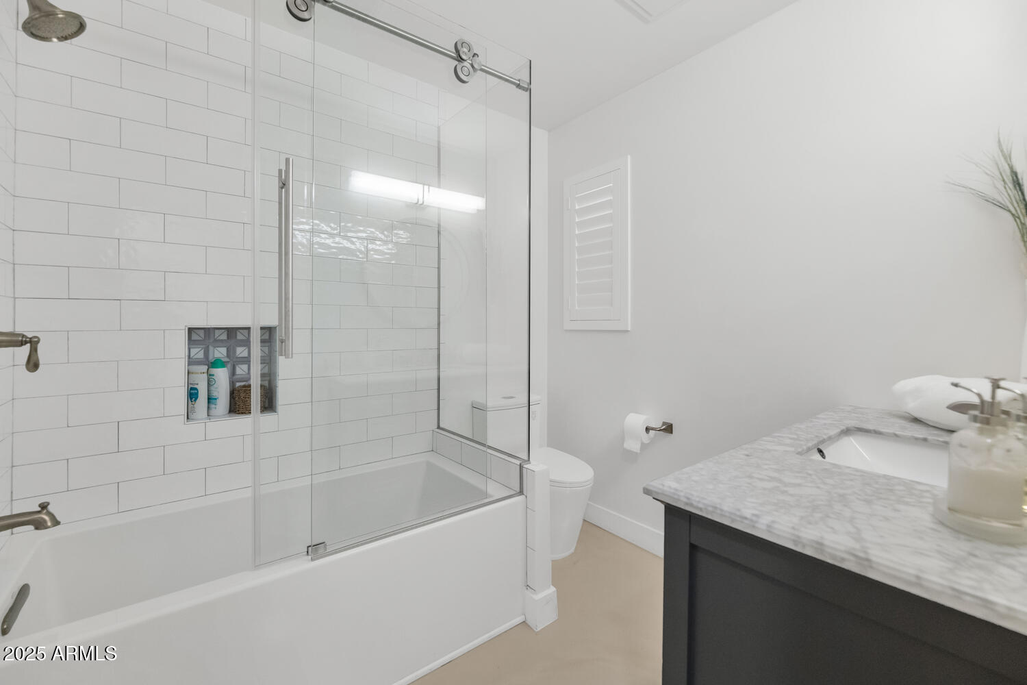 3420 East Oregon Avenue Phoenix, AZ 85018 - Photo 18 of 29 a bathroom with a granite countertop sink a toilet and shower