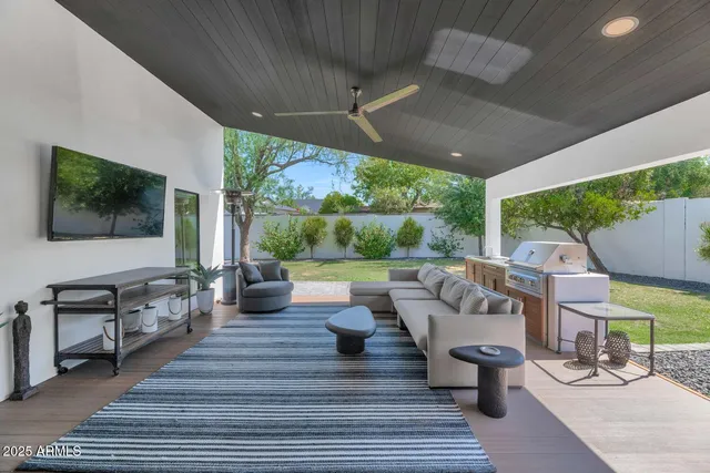a living room with patio furniture and a fireplace