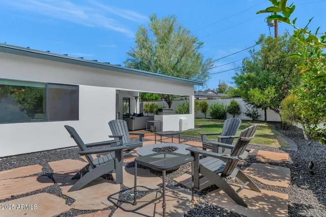a view of a patio with table and chairs and potted plants