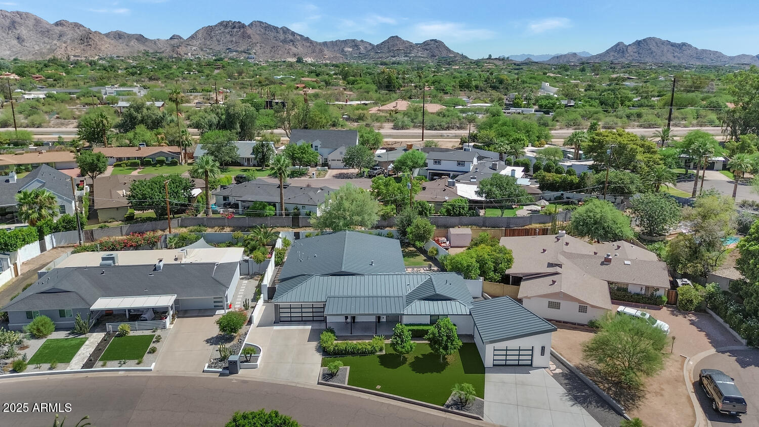 3420 East Oregon Avenue Phoenix, AZ 85018 - Photo 27 of 29 an aerial view of a city with lots of residential buildings and mountain view in back