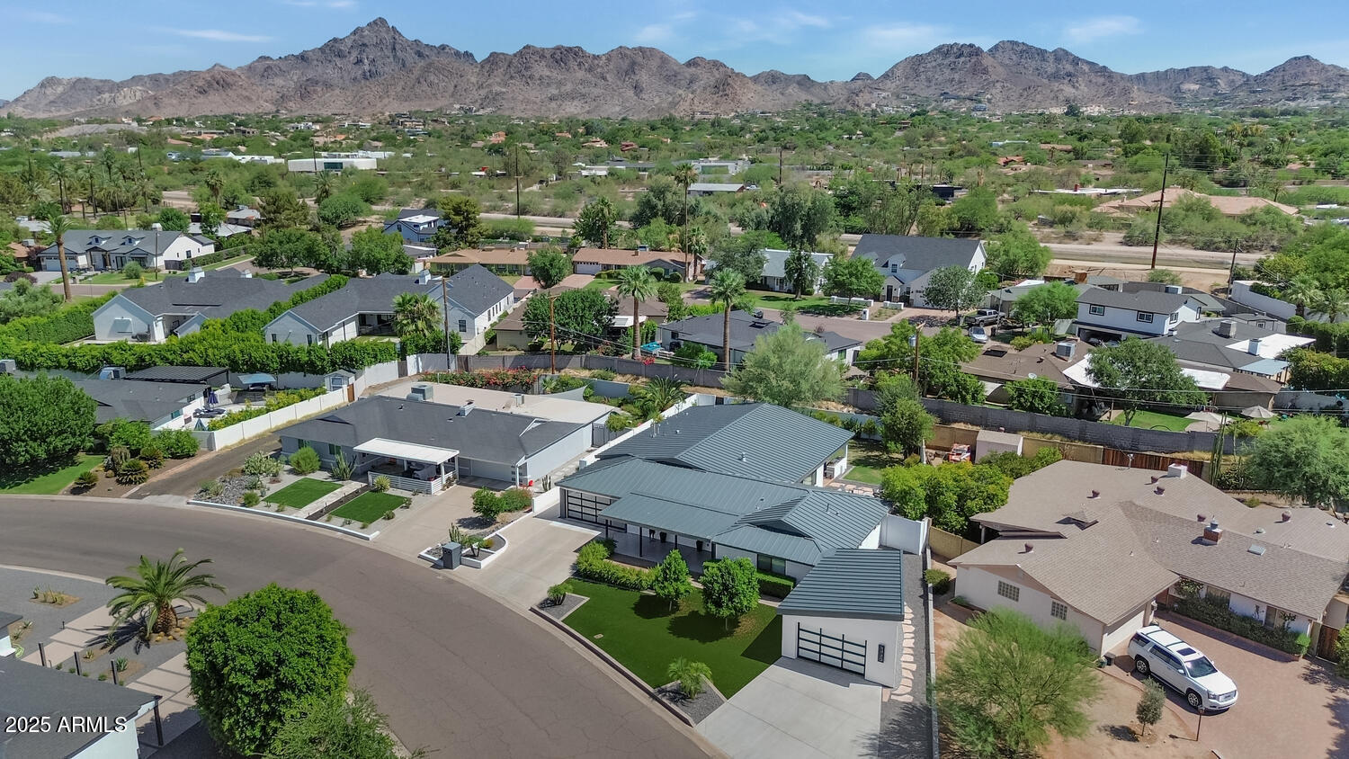 3420 East Oregon Avenue Phoenix, AZ 85018 - Photo 28 of 29 an aerial view of a city with lots of residential buildings and mountain view in back