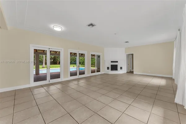 an empty room with wooden floor and a window