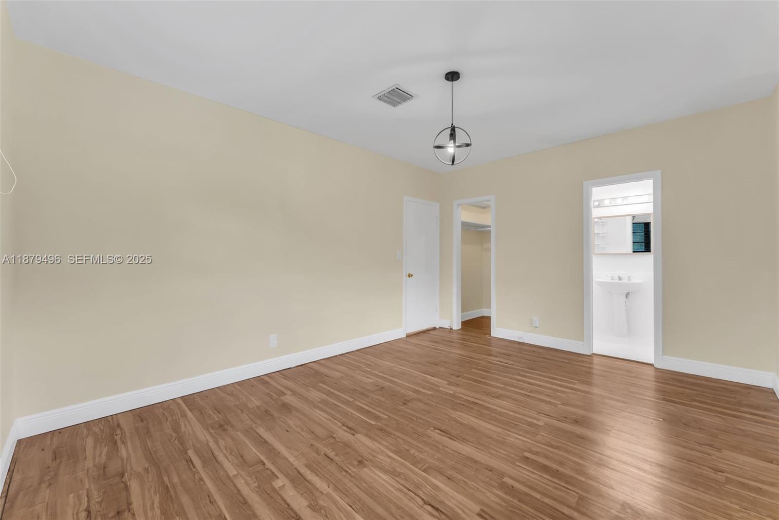 6275 Southwest 123rd Terrace Pinecrest, FL 33156 - Photo 21 of 49 a view of empty room with wooden floor and ceiling fan