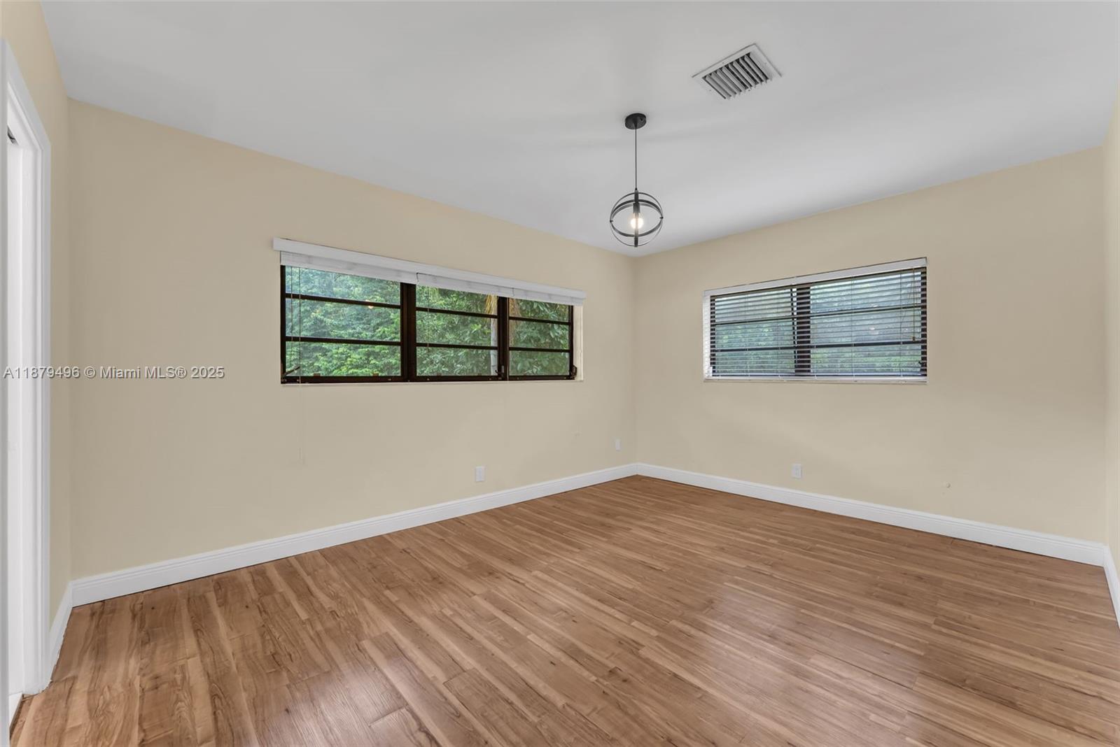 6275 Southwest 123rd Terrace Pinecrest, FL 33156 - Photo 23 of 49 wooden floor in an empty room with a window