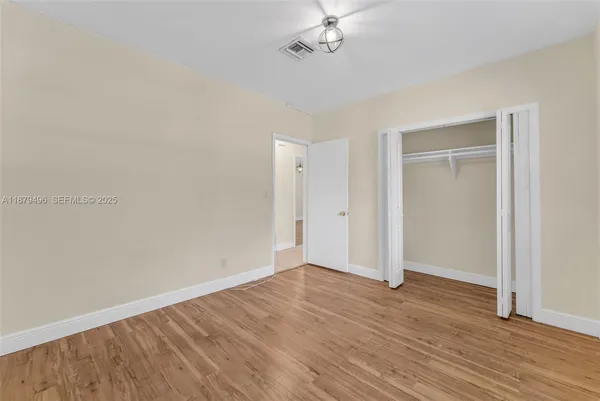 a bedroom with bed and a window