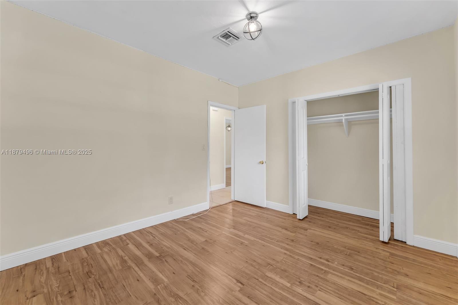 6275 Southwest 123rd Terrace Pinecrest, FL 33156 - Photo 24 of 49 a view of an empty room with wooden floor