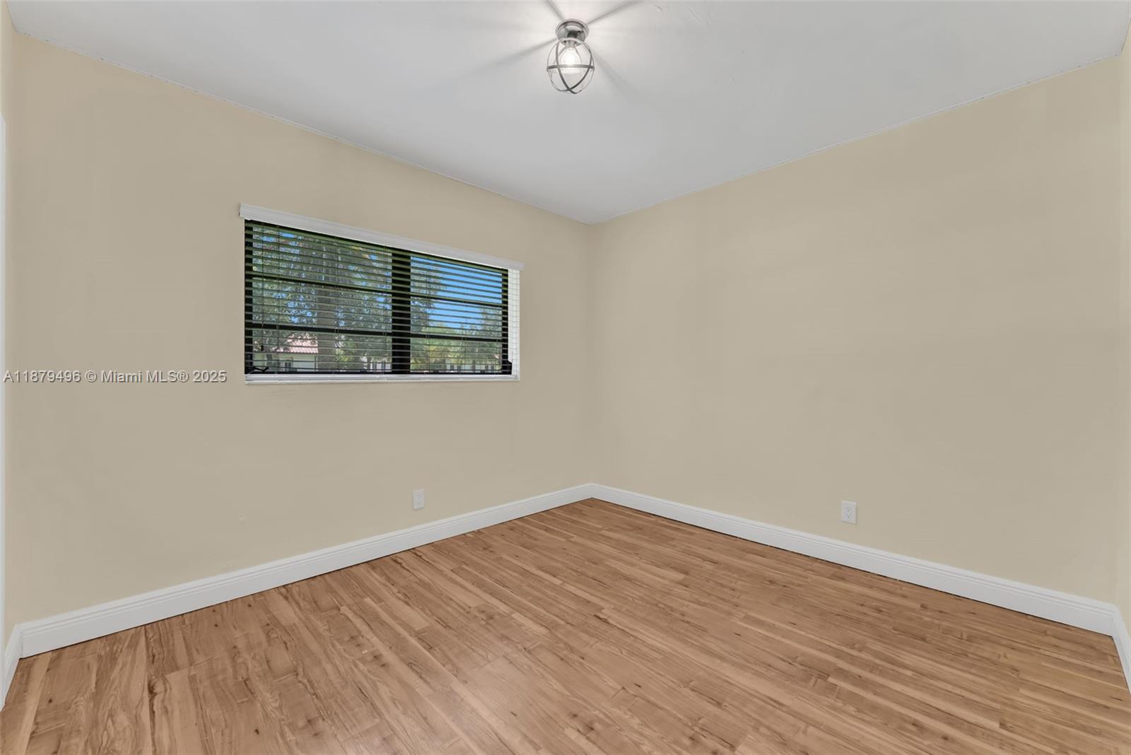 6275 Southwest 123rd Terrace Pinecrest, FL 33156 - Photo 26 of 49 wooden floor in an empty room with a window