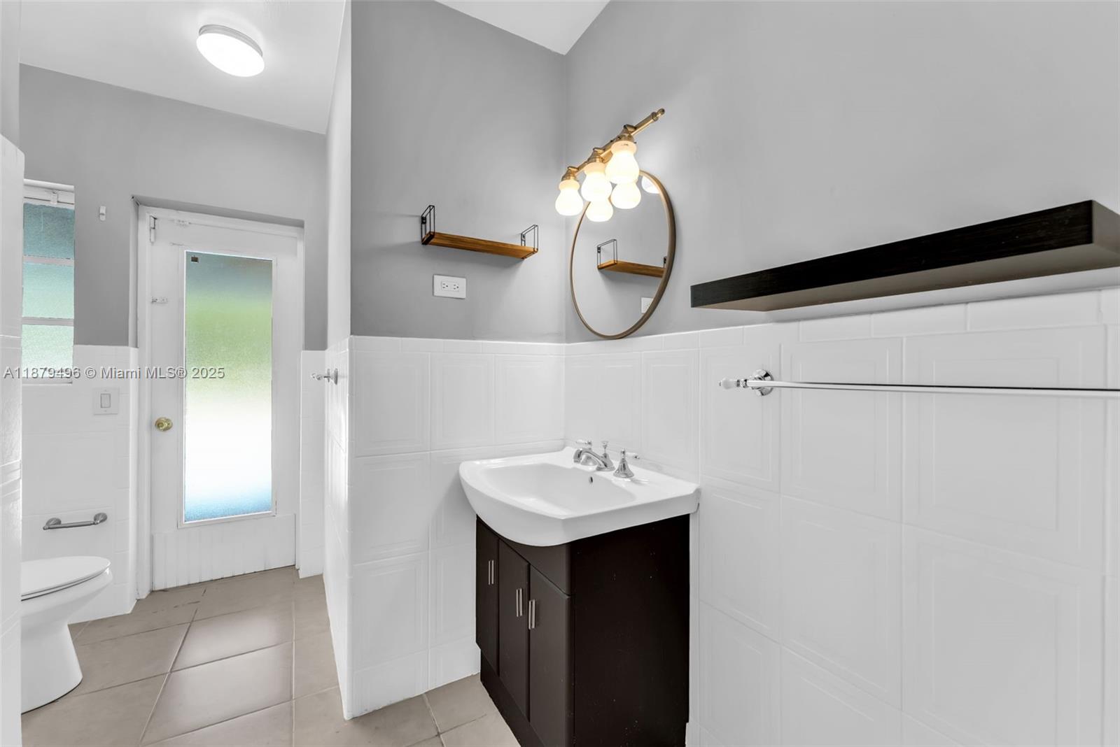 6275 Southwest 123rd Terrace Pinecrest, FL 33156 - Photo 28 of 49 a bathroom with a sink and a mirror