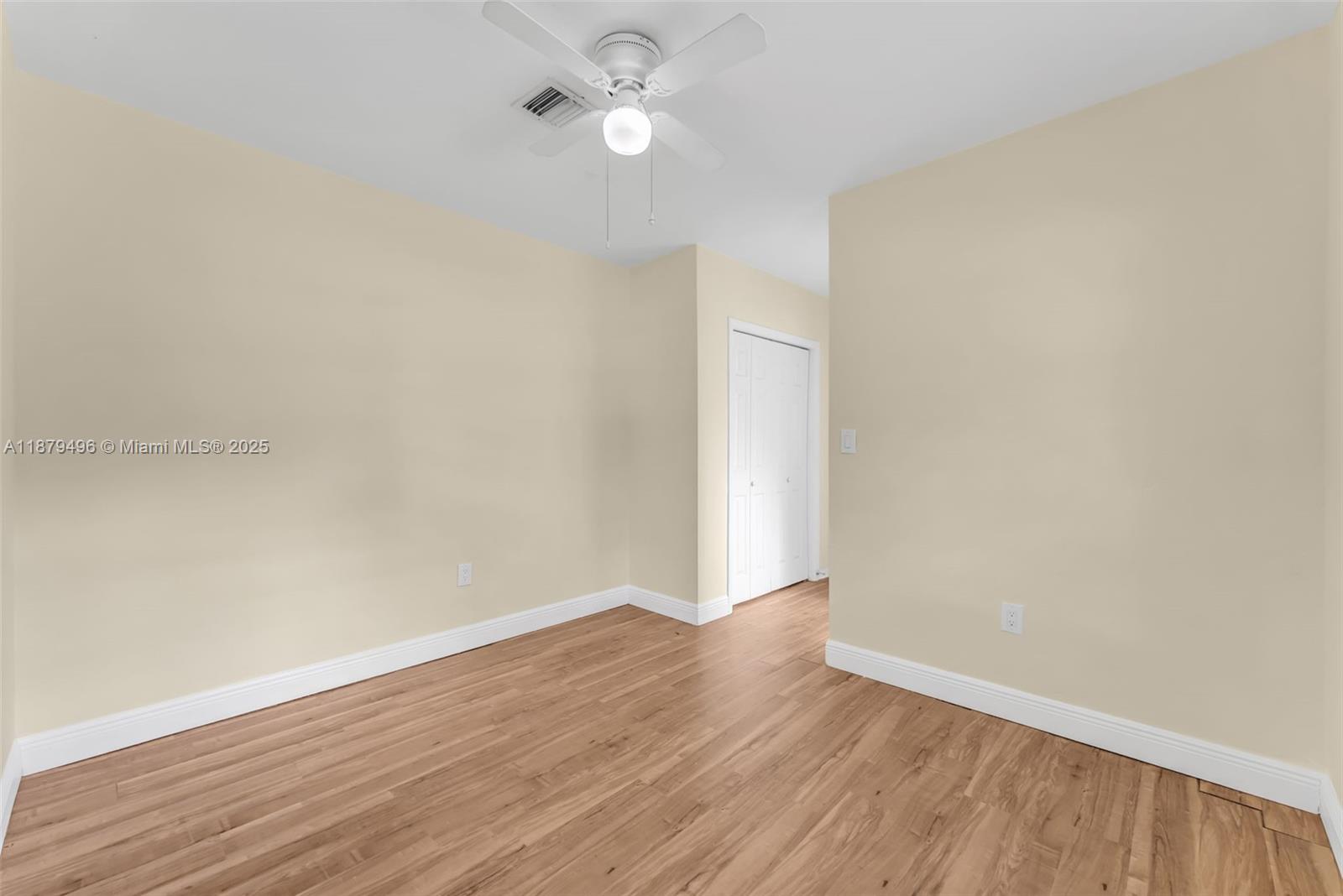 6275 Southwest 123rd Terrace Pinecrest, FL 33156 - Photo 29 of 49 an empty room with wooden floor and fan