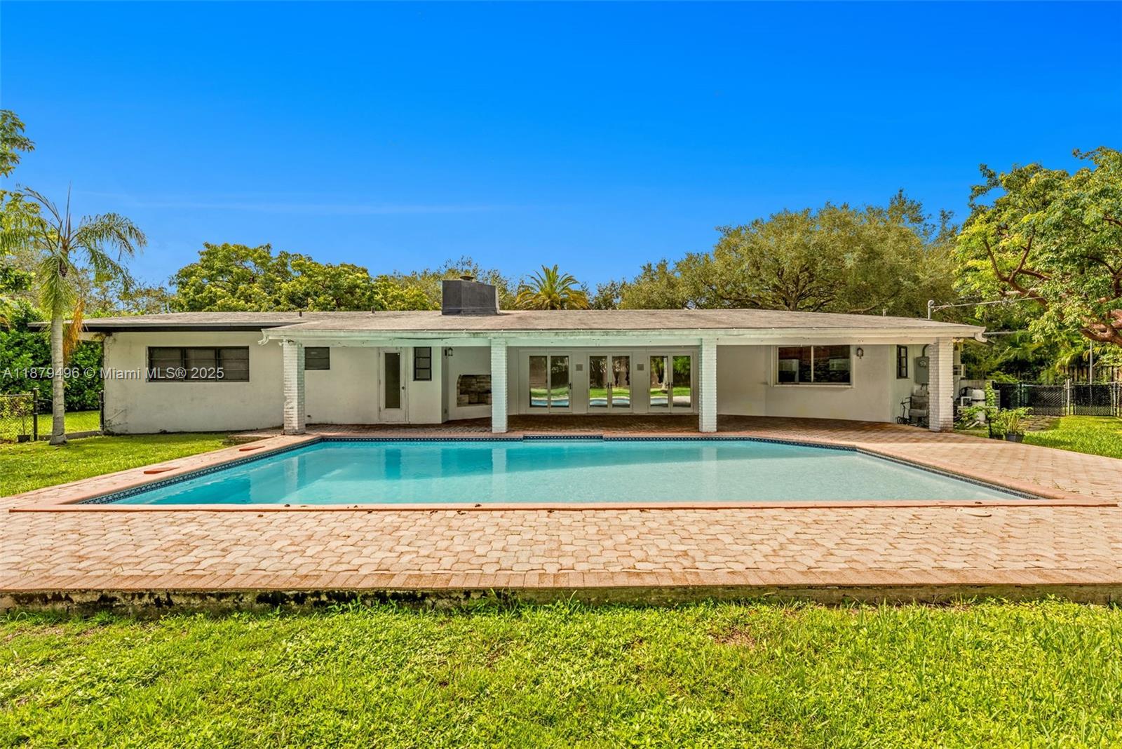 6275 Southwest 123rd Terrace Pinecrest, FL 33156 - Photo 3 of 49 a house view with a seating space and garden