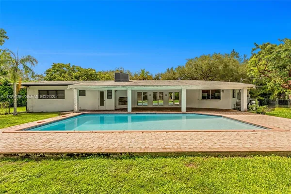 a house view with a seating space and garden