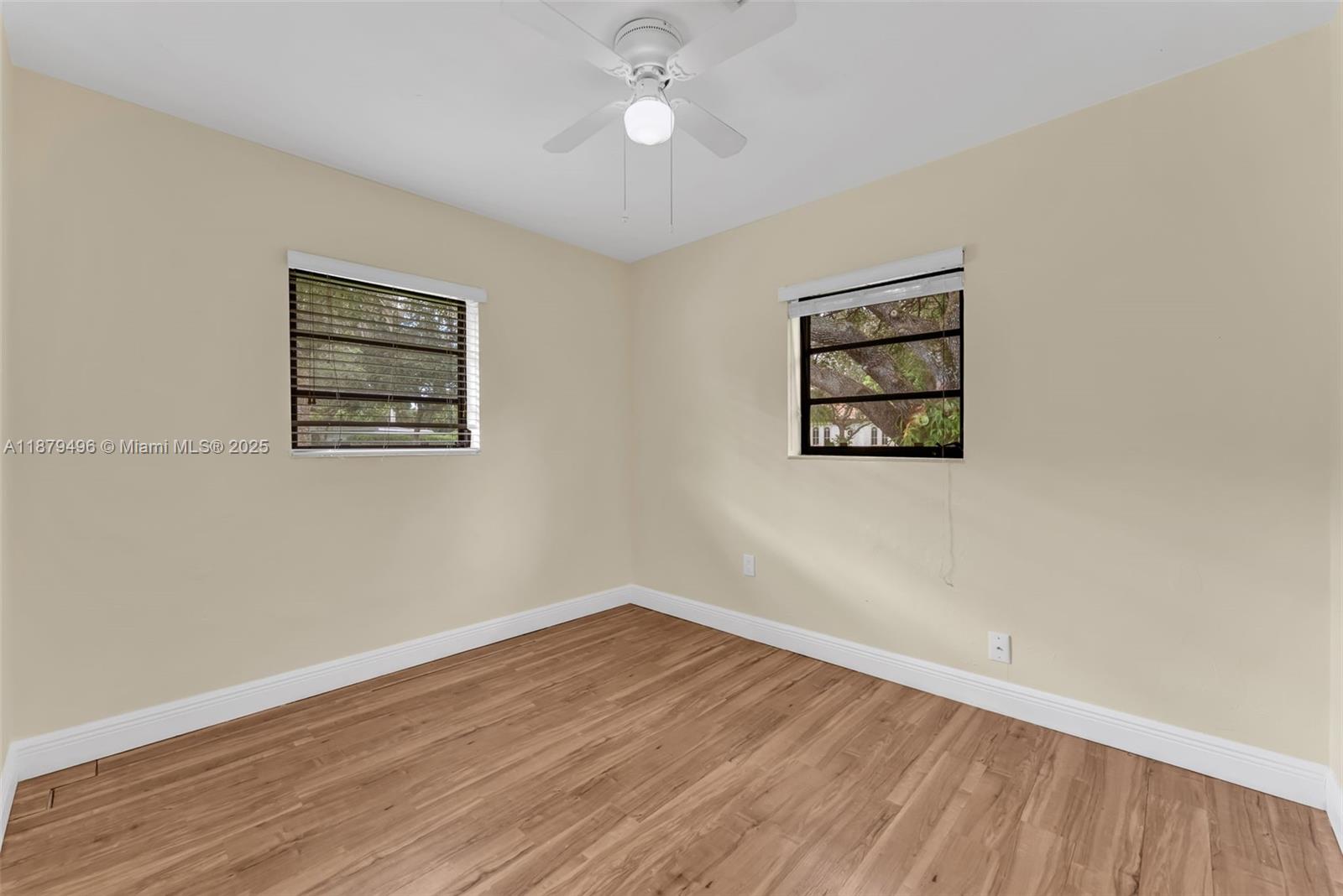 6275 Southwest 123rd Terrace Pinecrest, FL 33156 - Photo 31 of 49 wooden floor in an empty room with a window