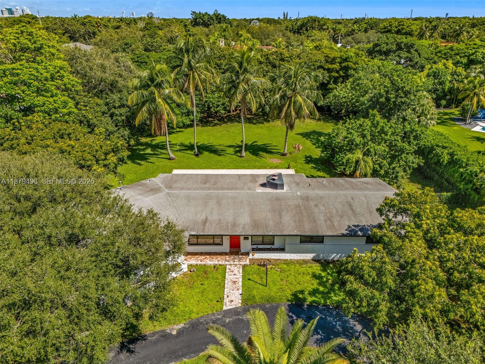 6275 Southwest 123rd Terrace Pinecrest, FL 33156 - Photo 34 of 49 an aerial view of a house with yard swimming pool and outdoor seating