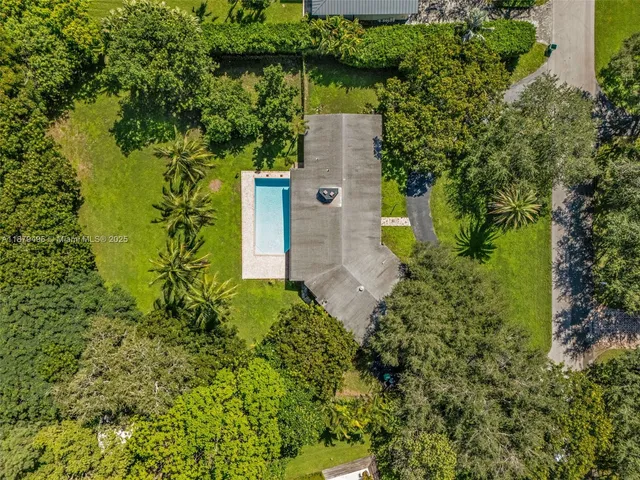 an aerial view of a house with a yard