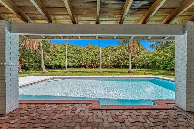 a view of a swimming pool with a yard