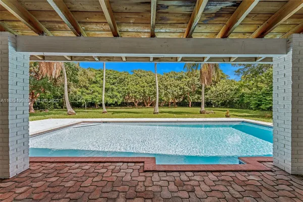 a view of a swimming pool with a yard