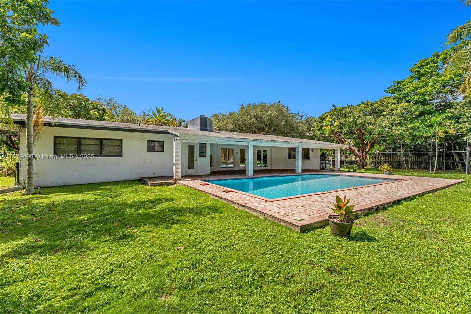 6275 Southwest 123rd Terrace Pinecrest, FL 33156 - Photo 43 of 49 a view of a house with a backyard
