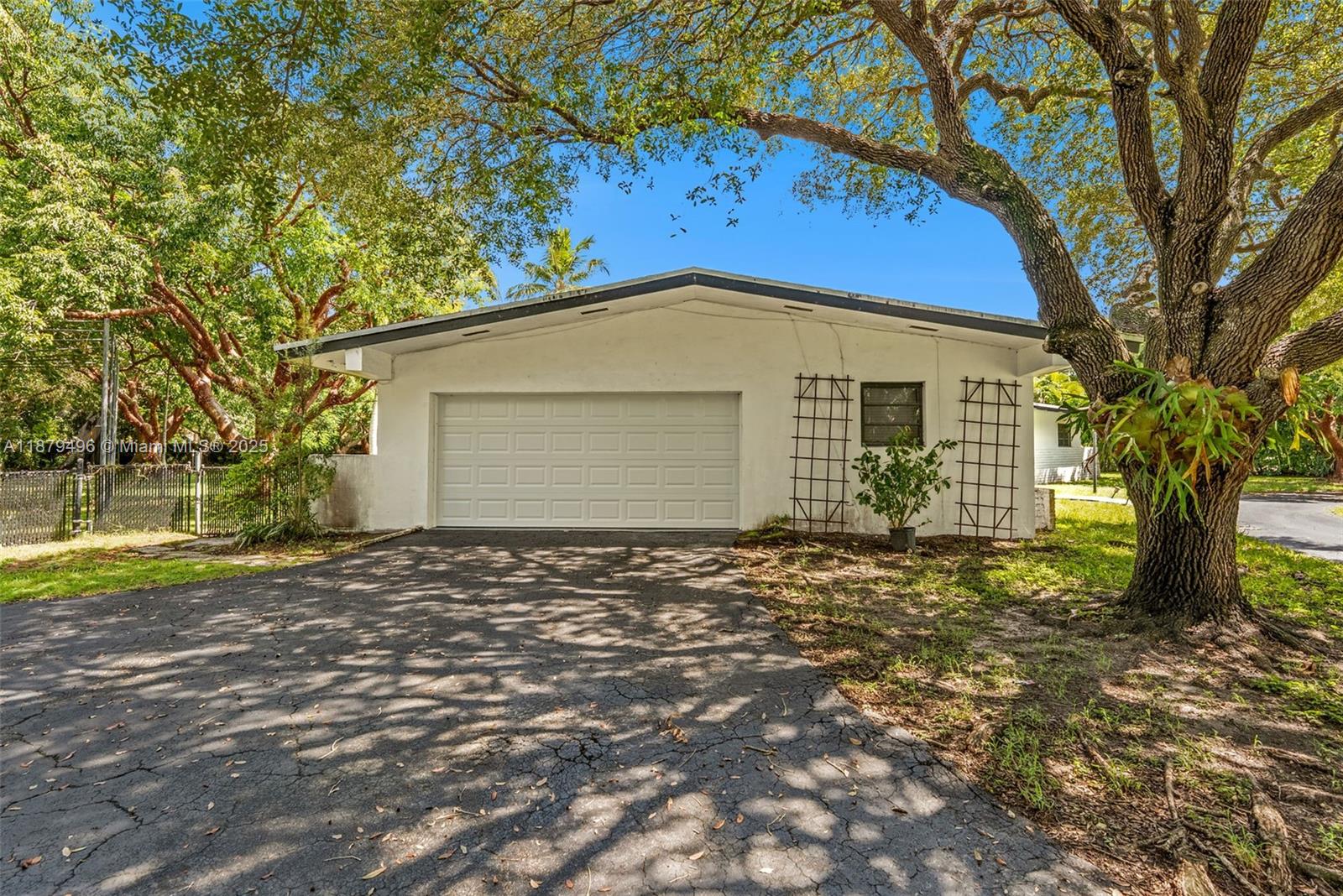 6275 Southwest 123rd Terrace Pinecrest, FL 33156 - Photo 44 of 49 a front view of a house with a garden