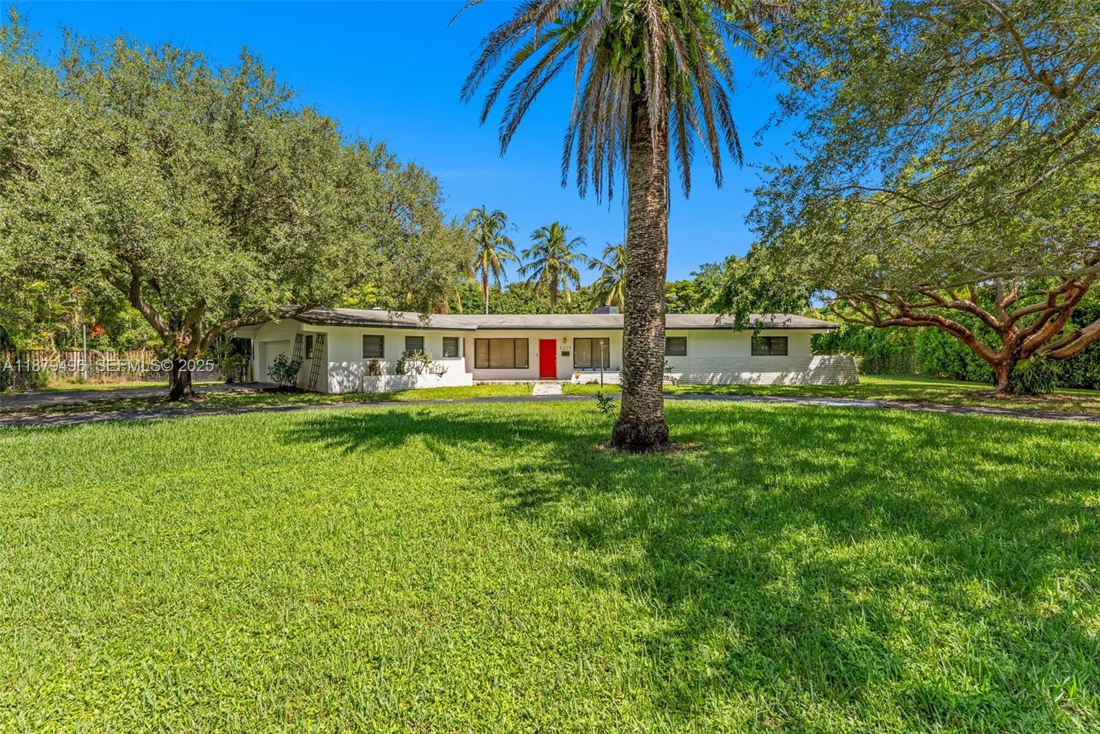 6275 Southwest 123rd Terrace Pinecrest, FL 33156 - Photo 46 of 49 a house view with a swimming pool and garden