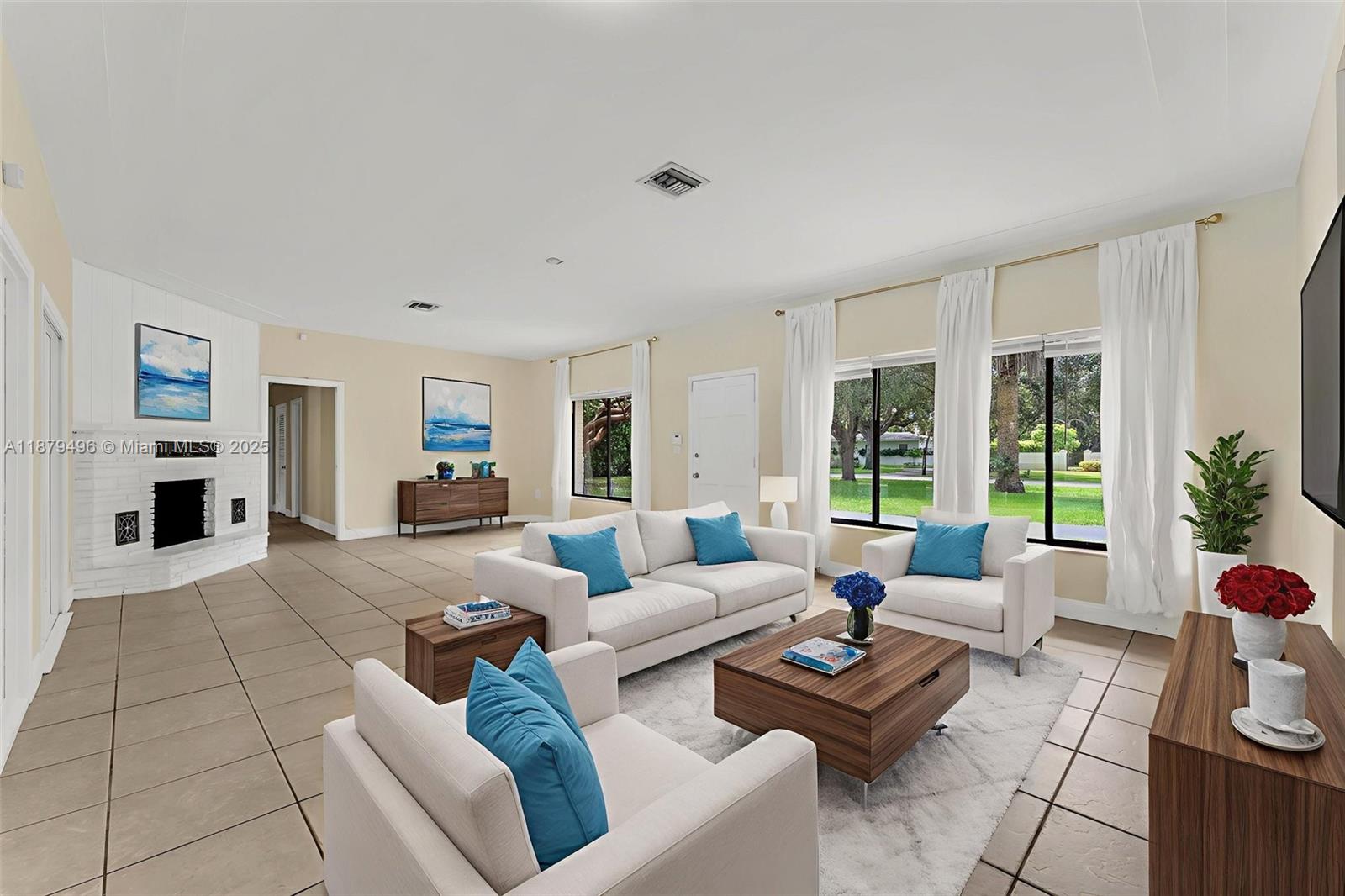6275 Southwest 123rd Terrace Pinecrest, FL 33156 - Photo 9 of 49 a living room with furniture and a large window